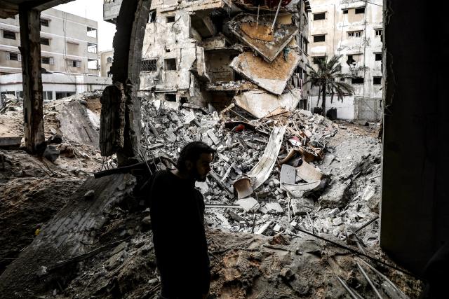 (260131) -- GAZA, Jan. 31, 2026 (Xinhua) -- A Palestinian checks the damaged buildings following Israeli airstrikes in Gaza City, on Jan. 31, 2026. At least 12 people were killed in Israeli airstrikes on Gaza on Saturday, multiple sources reported, citing hospital officials in the enclave. (Photo by Rizek Abdeljawad/Xinhua)