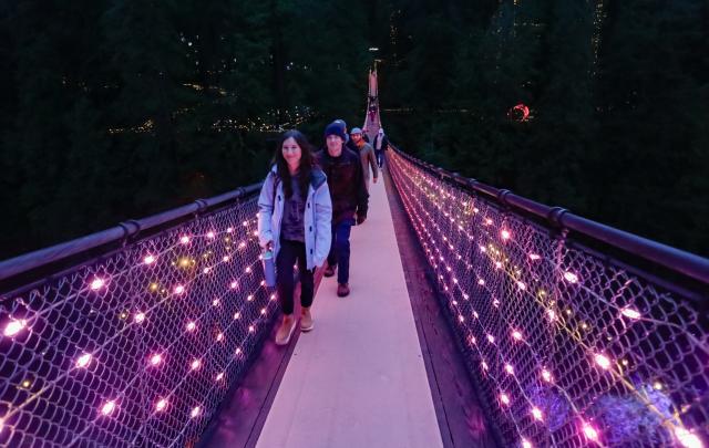 (260201) -- NORTH VANCOUVER, Feb. 1, 2026 (Xinhua) -- People walk across an illuminated suspension bridge during the "Love Lights" event at Capilano Suspension Bridge Park in North Vancouver, British Columbia, Canada, on Jan. 31, 2026. "Love Lights" is a Valentine's Day-themed attraction featuring romantic illuminations and decorations throughout the park. The event kicked off on Jan. 30 and will last until Feb. 22. (Photo by Liang Sen/Xinhua)