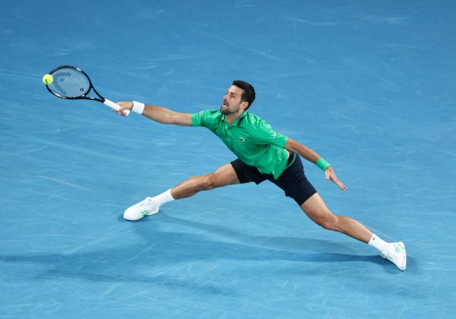 (260201) -- MELBOURNE, Feb. 1, 2026 (Xinhua) -- Novak Djokovic hits a return during the men's singles final between Carlos Alcaraz of Spain and Novak Djokovic of Serbia at the Australian Open tennis tournament in Melbourne, Australia, Feb. 1, 2026. (Xinhua/Ma Ping)