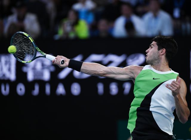 (260201) -- MELBOURNE, Feb. 1, 2026 (Xinhua) -- Carlos Alcaraz hits a return during the men's singles final between Carlos Alcaraz of Spain and Novak Djokovic of Serbia at the Australian Open tennis tournament in Melbourne, Australia, Feb. 1, 2026. (Photo by Wang Shen/Xinhua)