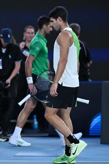 (260201) -- MELBOURNE, Feb. 1, 2026 (Xinhua) -- Carlos Alcaraz (R) reacts during the men's singles final between Carlos Alcaraz of Spain and Novak Djokovic of Serbia at the Australian Open tennis tournament in Melbourne, Australia, Feb. 1, 2026. (Photo by Wang Shen/Xinhua)