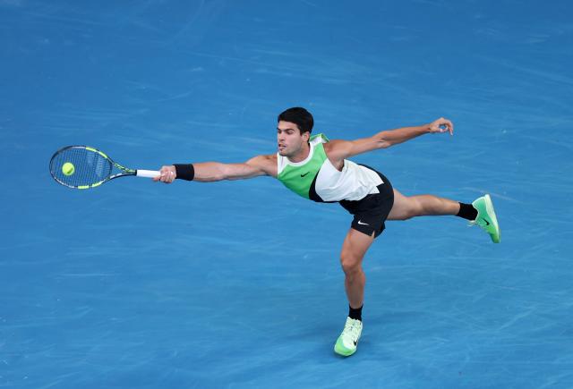 (260201) -- MELBOURNE, Feb. 1, 2026 (Xinhua) -- Carlos Alcaraz hits a return during the men's singles final between Carlos Alcaraz of Spain and Novak Djokovic of Serbia at the Australian Open tennis tournament in Melbourne, Australia, Feb. 1, 2026. (Xinhua/Ma Ping)