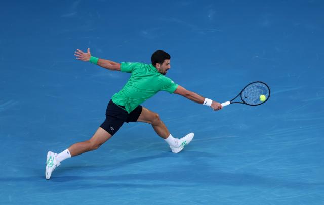 (260201) -- MELBOURNE, Feb. 1, 2026 (Xinhua) -- Novak Djokovic hits a return during the men's singles final between Carlos Alcaraz of Spain and Novak Djokovic of Serbia at the Australian Open tennis tournament in Melbourne, Australia, Feb. 1, 2026. (Xinhua/Ma Ping)