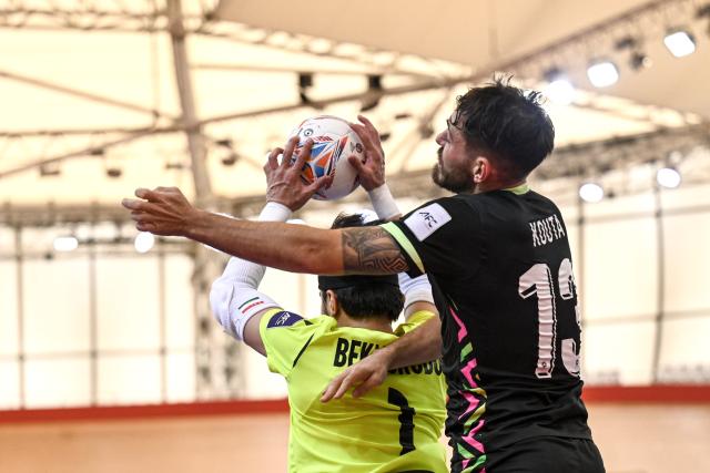 (260201) -- JAKARTA, Feb. 1, 2026 (Xinhua) -- Bekmurodov Firuz  (L), goalkeeper of Tajikistan vies with Michael Panayiotis Kouta of Australia during the Group C match between Tajikistan and Australia at the AFC Futsal Asian Cup 2026 in Jakarta, Indonesia, Feb. 1, 2026. (Xinhua/Agung Kuncahya B.)