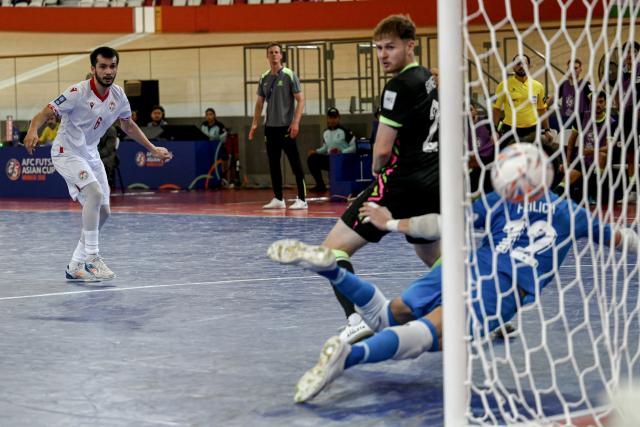 (260201) -- JAKARTA, Feb. 1, 2026 (Xinhua) -- Yorov Idris (L) of Tajikistan shoots during the Group C match between Tajikistan and Australia at the AFC Futsal Asian Cup 2026 in Jakarta, Indonesia, Feb. 1, 2026. (Xinhua/Agung Kuncahya B.)