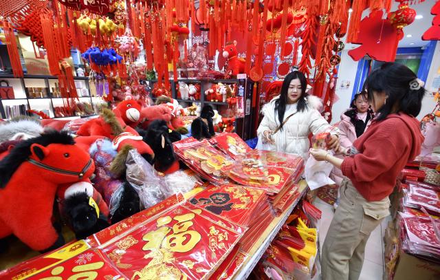 (260201) -- BEIJING, Feb. 1, 2026 (Xinhua) -- People shop for festive decorations at a shopping mall in Beijing, capital of China, Jan. 31, 2026. With the approach of the Spring Festival, shopping malls across Beijing have begun selling festive decorations. (Xinhua/Li Xin)