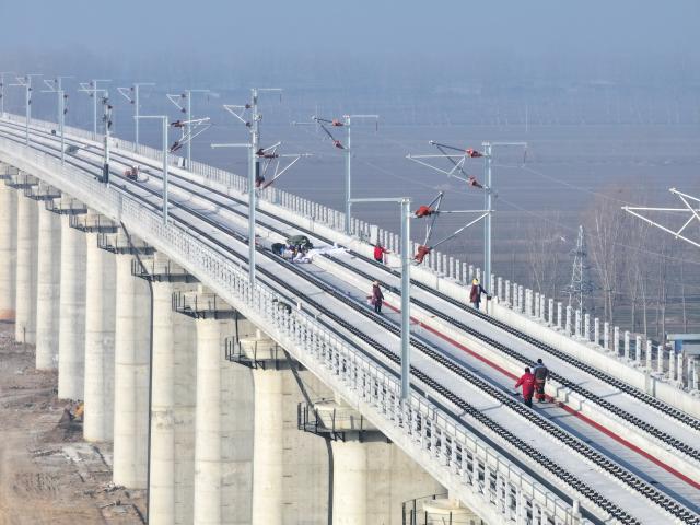 (260201) -- SHIJIAZHUANG, Feb. 1, 2026 (Xinhua) -- An aerial drone photo taken on Feb. 1, 2026 shows constructors working at the construction site of the Xiong'an-Xinzhou high-speed railway in Baoding, north China's Hebei Province. Track-laying operation of the Xiong'an-Xinzhou high-speed railway officially kicked off on Sunday.
   The Xiong'an-Xinzhou high-speed railway is a pivotal section of the Beijing-Kunming high-speed railway that belongs to a greater high-speed rail artery network consisting eight vertical lines and eight horizontal lines in the country. (Xinhua/Zhu Xudong)