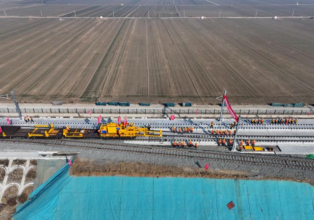 (260201) -- SHIJIAZHUANG, Feb. 1, 2026 (Xinhua) -- An aerial drone photo taken on Feb. 1, 2026 shows constructors working at the construction site of the Xiong'an-Xinzhou high-speed railway in Baoding, north China's Hebei Province. Track-laying operation of the Xiong'an-Xinzhou high-speed railway officially kicked off on Sunday.
   The Xiong'an-Xinzhou high-speed railway is a pivotal section of the Beijing-Kunming high-speed railway that belongs to a greater high-speed rail artery network consisting eight vertical lines and eight horizontal lines in the country. (Xinhua/Mu Yu)
