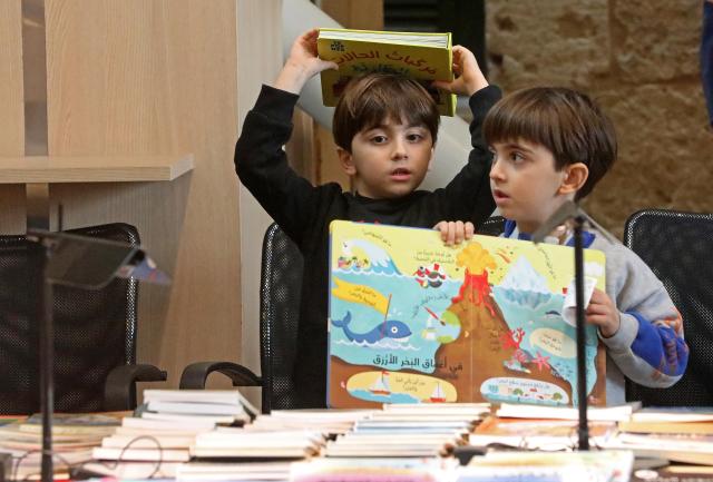 (260201) -- BEIRUT, Feb. 1, 2026 (Xinhua) -- Children read at the 2026 Children's Book Fair held at the National Library in Beirut, Lebanon, Jan. 31, 2026. (Photo by Bilal Jawich/Xinhua)