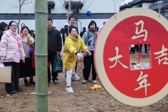 (260201) -- JIANDE, Feb. 1, 2026 (Xinhua) -- People participate in a traditional game during a Spring Festival cultural event in Lianhua Township, east China's Zhejiang Province, Feb. 1, 2026. A Spring Festival cultural event was held here with great enthusiasm on Sunday. Local residents and tourists enjoyed the festive market, viewed the local art exhibition, participated in traditional games, and savored local foods. (Xinhua/Xu Yu)
