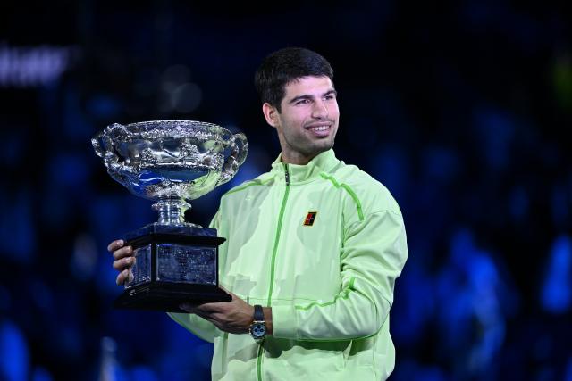 (260201) -- MELBOURNE, Feb. 1, 2026 (Xinhua) -- Carlos Alcaraz celebrates with the trophy after winning the men's singles final between Carlos Alcaraz of Spain and Novak Djokovic of Serbia at the Australian Open tennis tournament in Melbourne, Australia, Feb. 1, 2026. (Photo by Wang Shen/Xinhua)