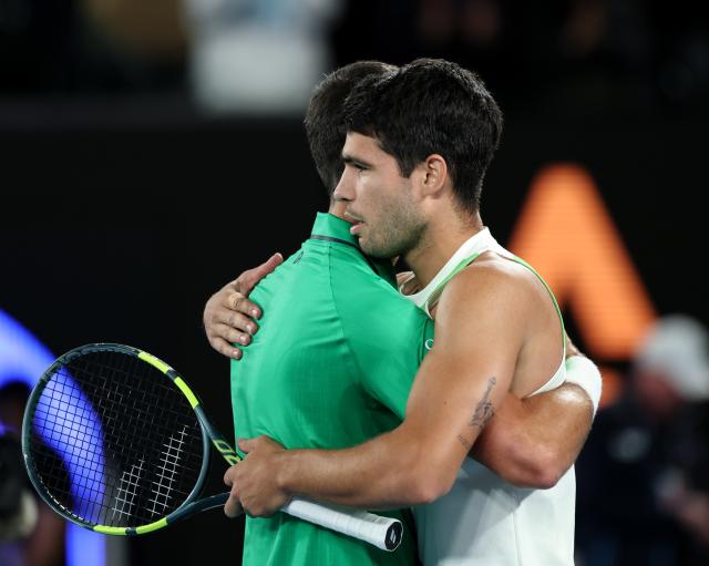 (260201) -- MELBOURNE, Feb. 1, 2026 (Xinhua) -- Carlos Alcaraz (R) greets Novak Djokovic after the men's singles final between Carlos Alcaraz of Spain and Novak Djokovic of Serbia at the Australian Open tennis tournament in Melbourne, Australia, Feb. 1, 2026. (Xinhua/Ma Ping)