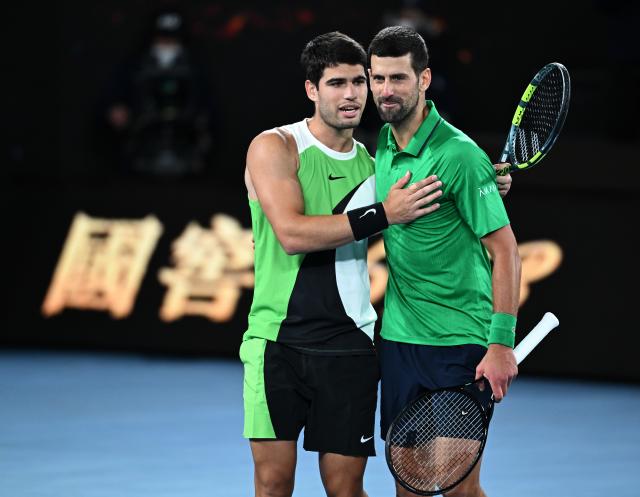 (260201) -- MELBOURNE, Feb. 1, 2026 (Xinhua) -- Carlos Alcaraz (L) greets Novak Djokovic after the men's singles final between Carlos Alcaraz of Spain and Novak Djokovic of Serbia at the Australian Open tennis tournament in Melbourne, Australia, Feb. 1, 2026. (Photo by Wang Shen/Xinhua)
