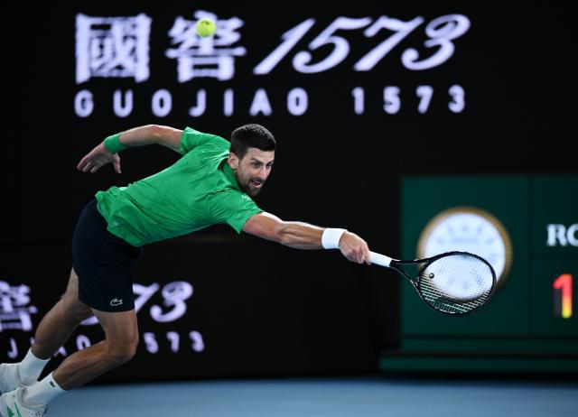 (260201) -- MELBOURNE, Feb. 1, 2026 (Xinhua) -- Novak Djokovic hits a return during the men's singles final between Carlos Alcaraz of Spain and Novak Djokovic of Serbia at the Australian Open tennis tournament in Melbourne, Australia, Feb. 1, 2026. (Photo by Wang Shen/Xinhua)