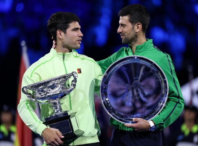 (260201) -- MELBOURNE, Feb. 1, 2026 (Xinhua) -- Carlos Alcaraz (L) and Novak Djokovic pose for photos after the men's singles final between Carlos Alcaraz of Spain and Novak Djokovic of Serbia at the Australian Open tennis tournament in Melbourne, Australia, Feb. 1, 2026. (Xinhua/Ma Ping)