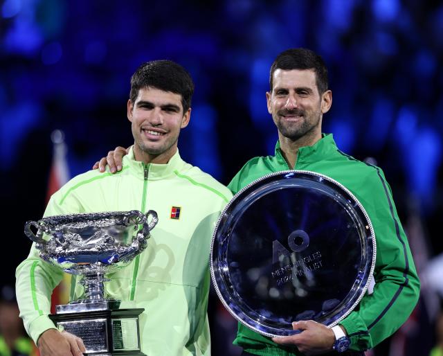 (260201) -- MELBOURNE, Feb. 1, 2026 (Xinhua) -- Carlos Alcaraz (L) and Novak Djokovic pose for photos at the awarding ceremony after the men's singles final between Carlos Alcaraz of Spain and Novak Djokovic of Serbia at the Australian Open tennis tournament in Melbourne, Australia, Feb. 1, 2026. (Xinhua/Ma Ping)