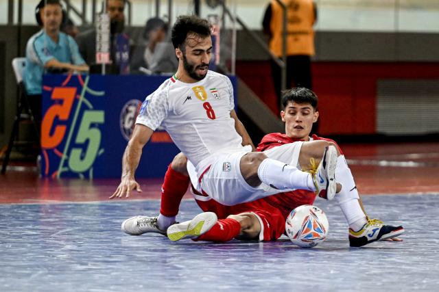 (260201) -- JAKARTA, Feb. 1, 2026 (Xinhua) -- Moslem Oladghobad (L) of Iran competes during the Group D match between Iran and Afghanistan at the AFC Futsal Asian Cup 2026 in Jakarta, Indonesia, Feb. 1, 2026. (Xinhua/Agung Kuncahya B.)