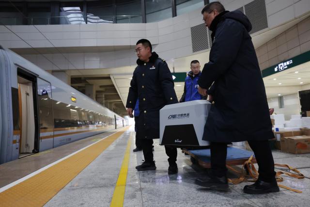 (260201) -- LANZHOU, Feb. 1, 2026 (Xinhua) -- Staff members load a pet passenger onto the high-speed train at Lanzhou West Railway Station, in Lanzhou, northwest China's Gansu Province, Feb. 1, 2026. With the arrival of the Spring Festival travel season, Lanzhou West Railway Station has welcomed a number of pet passengers. These pet passengers are specially monitored and looked after by train staff, traveling in dedicated pet transport cases equipped with intelligent monitoring systems.
   Since Jan. 28, the railway authorities have further increased the number of high-speed railway stations with pet consignment services. Passengers can make online reservations through the 12306 app or WeChat mini-program, making pet travel more convenient during the Spring Festival period. (Xinhua/Chen Bin)