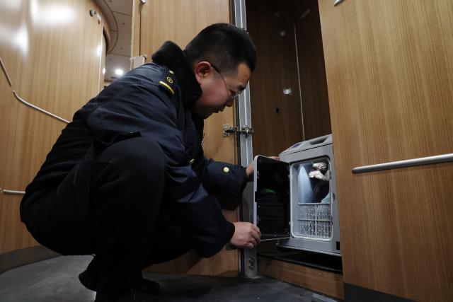 (260201) -- LANZHOU, Feb. 1, 2026 (Xinhua) -- A staff member checks the condition of a pet through the crate at Lanzhou West Railway Station, in Lanzhou, northwest China's Gansu Province, Feb. 1, 2026. With the arrival of the Spring Festival travel season, Lanzhou West Railway Station has welcomed a number of pet passengers. These pet passengers are specially monitored and looked after by train staff, traveling in dedicated pet transport cases equipped with intelligent monitoring systems.
   Since Jan. 28, the railway authorities have further increased the number of high-speed railway stations with pet consignment services. Passengers can make online reservations through the 12306 app or WeChat mini-program, making pet travel more convenient during the Spring Festival period. (Xinhua/Chen Bin)