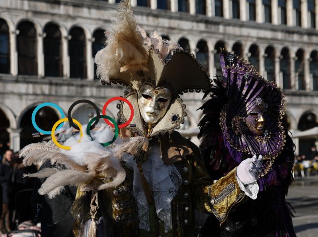 (260202) -- VENICE, Feb. 2, 2026 (Xinhua) -- Revelers dressed up in theme of the Olympic Games pose during Venice Carnival at St. Mark's Square in Venice, Italy, Feb. 1, 2026. The 2026 version of the traditional Venice Carnival runs from Jan. 31 to Feb. 17. (Xinhua/Li Jing)