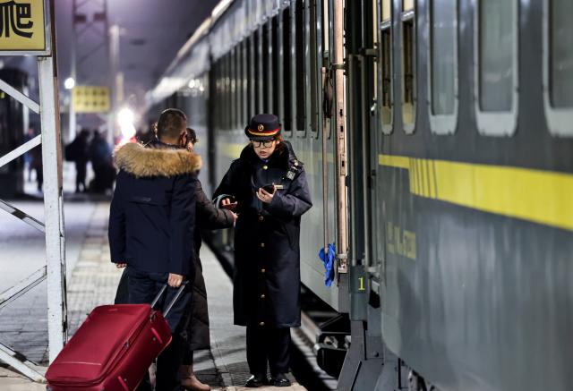 (260202) -- BEIJING, Feb. 2, 2026 (Xinhua) -- A staff member checks tickets for passengers at Lanzhou Railway Station in Lanzhou, northwest China's Gansu Province, Feb. 2, 2026.
  China ushered in its largest annual population migration on Monday, 15 days ahead of the 2026 Spring Festival, also known as the Chinese New Year.
  A total of 9.5 billion passenger trips are expected during this year's travel rush period that will end on March 13, which will be a historic high.
  Of this total, road trips remain the dominant mode of travel, accounting for approximately 80 percent. 
  An estimated 540 million passenger trips will be handled by the country's railways, while the civil aviation sector will see 95 million trips. Both the overall scale and daily peak traffic of rail and air travel are expected to surpass historic high levels this year.
  In China, the 40-day travel surge will witness hundreds of millions of people return to their hometowns for family reunions. (Photo by Hou Chonghui/Xinhua)