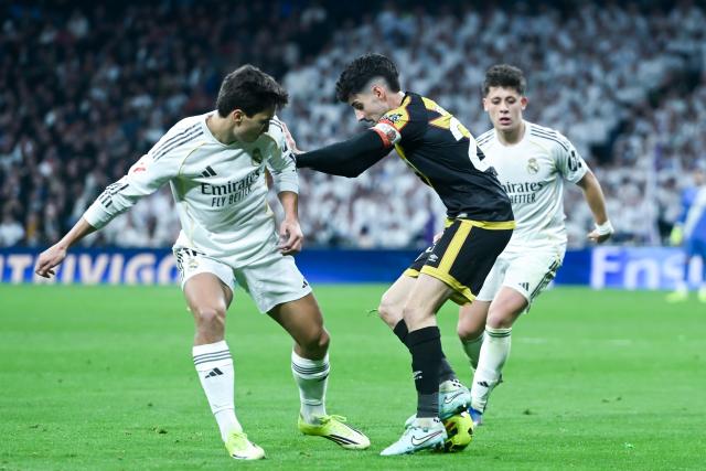 (260202) -- MADRID, Feb. 2, 2026 (Xinhua) -- Real Madrid's Gonzalo Garcia (L) vies with Rayo Vallecano's Oscar Valentin (C) during La Liga football match between Real Madrid and Rayo Vallecano in Madrid, Spain, Feb. 1, 2026. (Photo by Gustavo Valiente/Xinhua)