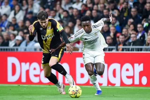 (260202) -- MADRID, Feb. 2, 2026 (Xinhua) -- Real Madrid's Vinicius Junior (R) vies with Rayo Vallecano's Andrei Ratiu during La Liga football match between Real Madrid and Rayo Vallecano in Madrid, Spain, Feb. 1, 2026. (Photo by Gustavo Valiente/Xinhua)