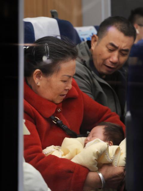 (260202) -- BEIJING, Feb. 2, 2026 (Xinhua) -- A woman takes care of an infant on a train at Shenzhen North Railway Station in Shenzhen, south China's Guangdong Province, Feb. 2, 2026. China ushered in its largest annual population migration on Monday, 15 days ahead of the 2026 Spring Festival, also known as the Chinese New Year.
  A total of 9.5 billion passenger trips are expected during this year's travel rush period that will end on March 13, which will be a historic high.
  Of this total, road trips remain the dominant mode of travel, accounting for approximately 80 percent. 
  An estimated 540 million passenger trips will be handled by the country's railways, while the civil aviation sector will see 95 million trips. Both the overall scale and daily peak traffic of rail and air travel are expected to surpass historic high levels this year.
  In China, the 40-day travel surge will witness hundreds of millions of people return to their hometowns for family reunions. (Xinhua/Mao Siqian)