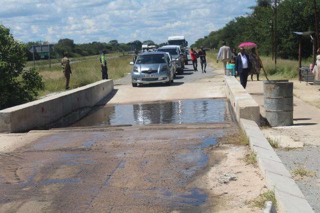 (260202) -- GABORONE, Feb. 2, 2026 (Xinhua) -- Vehicles wait to go through a disinfection pool at a disease control station along the road of Francistown-Jackalas I Village in North East District, Botswana, Feb. 1, 2026. Botswanan veterinary authorities on Sunday confirmed an outbreak of foot-and-mouth disease (FMD) at a village in the northeastern part of the southern African country, near the border with Zimbabwe. (Photo by Shingirai Madondo/Xinhua)