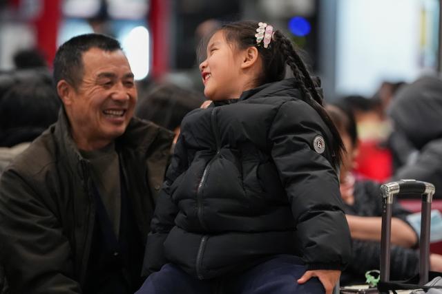 (260202) -- BEIJING, Feb. 2, 2026 (Xinhua) -- Five-year-old Dai Chenxi (R) plays with her grandfather at the departure hall of Beijing West Railway Station in Beijing, capital of China, Feb. 1, 2026. She will travel with her family on train No. K4069 back to her hometown Gushi in central China's Henan for the Spring Festival. China ushered in its largest annual population migration on Monday, 15 days ahead of the 2026 Spring Festival, also known as the Chinese New Year.
  A total of 9.5 billion passenger trips are expected during this year's travel rush period that will end on March 13, which will be a historic high. (Xinhua/Ju Huanzong)