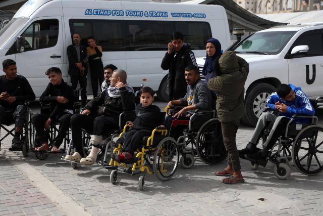 (260202) -- GAZA, Feb. 2, 2026 (Xinhua) -- Palestinian patients and their companions wait outside the Palestinian Red Crescent building in Khan Younis, southern Gaza Strip, as they prepare to cross through the Rafah border crossing for medical treatment, on Feb. 2, 2026. Some Palestinian patients started moving from the city of Khan Younis toward the Rafah land crossing in southern Gaza, in preparation for their travel abroad, Palestinian medical sources said Monday.
   Earlier on Monday, the crossing, the only channel linking Gaza with Egypt, was reopened in both directions on a limited and trial basis, as a number of Palestinians arrived on the Egyptian side of the crossing in preparation for entering Gaza, according to Palestinian sources. (Photo by Rizek Abdeljawad/Xinhua)