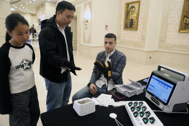 (260202) -- CAIRO, Feb. 2, 2026 (Xinhua) -- A man tries a medical device at an exhibition during the Joint International Pharmacy Conference 2026 in Cairo, Egypt, Feb. 1, 2026. The Joint International Pharmacy Conference 2026 wrapped up in Cairo on Monday after two days of discussions on combining Western pharmaceuticals and traditional Chinese medicine, with a focus on the use of artificial intelligence. (Xinhua/Ahmed Gomaa)