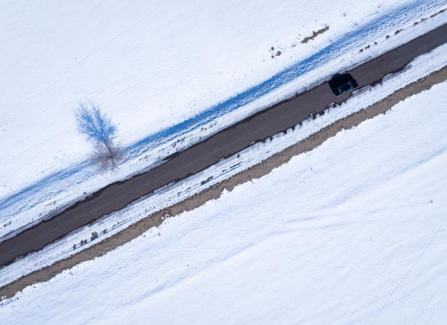 (260203) -- ALMATY, Feb. 3, 2026 (Xinhua) -- An aerial drone photo taken on Feb. 1, 2026 shows a car running on a road through a winter grassland in Almaty Region, Kazakhstan. (Xinhua/Li Renzi)