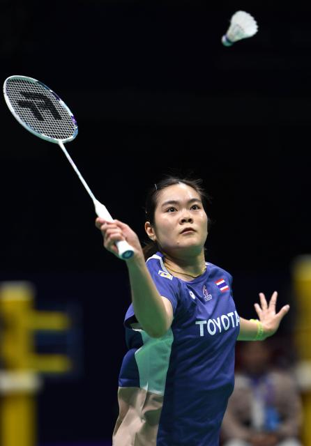 (260203) -- QINGDAO, Feb. 3, 2026 (Xinhua) -- Busanan Ongbamrunghan of Thailand hits a return in the women's singles match against Thet Htar Thuzar of Myanmar during the Group Y match between Thailand and Myanmar at Badminton Asia Team Championships 2026 in Qingdao, east China's Shandong Province, Feb. 3, 2026. (Xinhua/Li Ziheng)