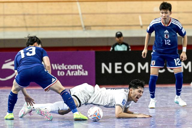 (260203) -- JAKARTA, Feb. 3, 2026 (Xinhua) -- Reza Hossein Poor (C) of Afghanistan reacts during the quarterfinal match between Japan and Afghanistan at the AFC Futsal Asian Cup 2026 in Jakarta, Indonesia, Feb. 3, 2026. (Xinhua/Agung Kuncahya B.)