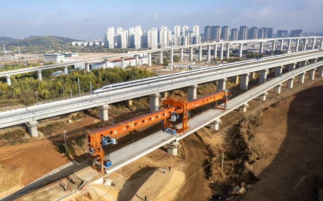 (260203) -- KUNMING, Feb. 3, 2026 (Xinhua) -- An aerial drone photo shows staff members working to position the last box girder of a bridge along the Chongqing-Kunming high-speed railway in Chenggong District of Kunming, southwest China's Yunnan Province, Feb. 3, 2026. As the last box girder of a bridge was precisely positioned on Tuesday, the construction of bridges along the Chongqing-Kunming High-Speed Railway was fully completed, paving way for subsequent construction work.
   When the Chongqing-Kunming high-speed railway opens to traffic, travel time between Chongqing and Kunming will be significantly reduced. This will boost connectivity between China's southwest region and the rest of the country, and promote coordinated regional economic development. (Xinhua/Chen Xinbo)