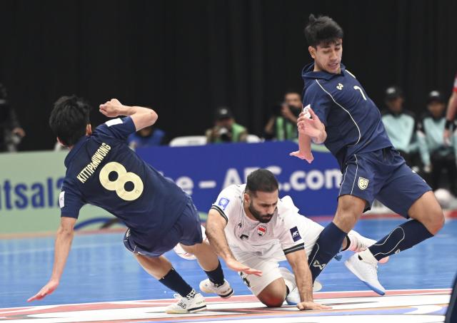 (260203) -- JAKARTA, Feb. 3, 2026 (Xinhua) -- Narongsak Wingwon (R) of Thailand vies with Mustafa Ihsan Al-Bayati (bottom) of Iraq during the quarterfinal match between Thailand and Iraq at the AFC Futsal Asian Cup 2026 in Jakarta, Indonesia, Feb. 3, 2026. (Xinhua/Zulkarnain)