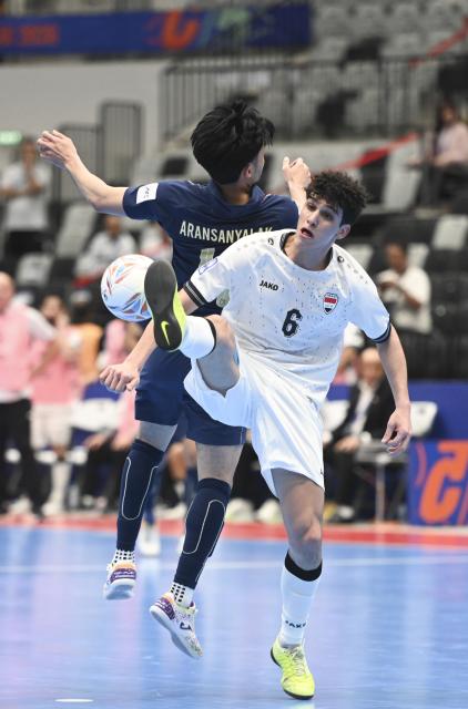 (260203) -- JAKARTA, Feb. 3, 2026 (Xinhua) -- Krit Aransanyalak (Back) of Thailand vies with Harith Saad Maroof Al-Obaidi of Iraq during the quarterfinal match between Thailand and Iraq at the AFC Futsal Asian Cup 2026 in Jakarta, Indonesia, Feb. 3, 2026. (Xinhua/Zulkarnain)