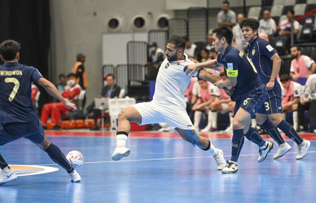 (260203) -- JAKARTA, Feb. 3, 2026 (Xinhua) -- Itticha Praphaphan (2nd R) of Thailand vies with Mustafa Ihsan Al-Bayati of Iraq during the quarterfinal match between Thailand and Iraq at the AFC Futsal Asian Cup 2026 in Jakarta, Indonesia, Feb. 3, 2026. (Xinhua/Zulkarnain)