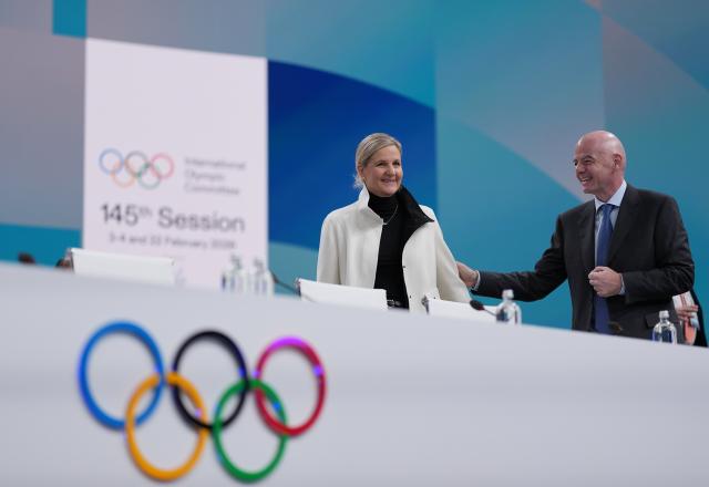 (260203) -- MILAN, Feb. 3, 2026 (Xinhua) -- International Olympic Committee (IOC) President Kirsty Coventry (L) speaks with FIFA President Gianni Infantino during the first day of the 145th IOC Session in Milan, Italy, Feb. 3, 2026. (Xinhua/Sun Fei)