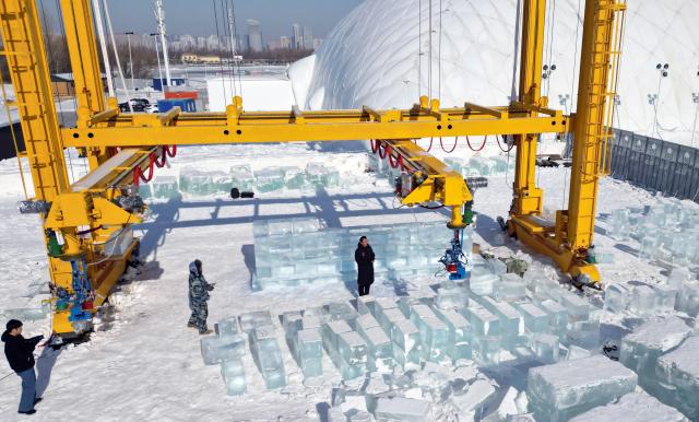 (260203) -- HARBIN, Feb. 3, 2026 (Xinhua) -- A drone photo taken on Feb. 3, 2026 shows an automated ice block stacking robot building a large-scale ice sculpture at the 27th Harbin Ice and Snow World in Harbin, northeast China's Heilongjiang Province. An automated ice block stacking robot has entered the testing phase at the 27th Harbin Ice and Snow World on Feb. 3. The robot is capable of lifting, transporting, and assembling ice blocks with millimeter-level precision. (Photo by Liu Yang/Xinhua)