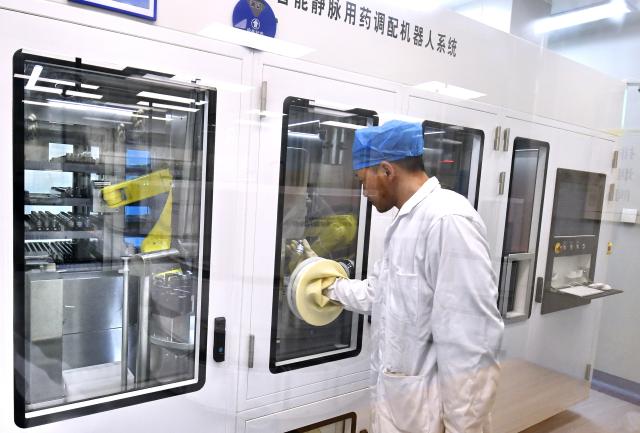 (260203) -- BEIJING, Feb. 3, 2026 (Xinhua) -- This photo shows an automatic intelligent intravenous drug compounding robot system at the Tongzhou branch of Beijing Anzhen Hospital in Beijing, capital of China, Feb. 3, 2026. Beijing Anzhen Hospital, designated by the Beijing municipal government as the city's first demonstration unit for "robots plus medical" applications, currently has 25 types of medical robots undergoing clinical trials. 
   These robots are deployed across various departments including outpatient clinics, pharmacies, wards, operating rooms, and catheterization rooms. 
   Serving as intelligent assistants to doctors, these robotic "staff members" are becoming a driving force in the hospital's smart transformation and upgrade. (Xinhua/Li Xin)