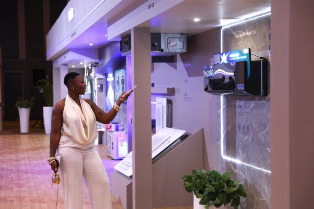 (260203) -- JOHANNESBURG, Feb. 3, 2026 (Xinhua) -- A woman tries products at Haier's launching event in Johannesburg, South Africa, Feb. 2, 2026. China's home appliance giant Haier on Monday held a launch ceremony in Johannesburg, South Africa's economic hub, marking its official entry into the South African market. (Xinhua/Chen Wei)