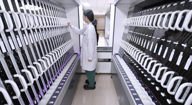 (260203) -- BEIJING, Feb. 3, 2026 (Xinhua) -- A medical worker inspects an injection solution dispensing robot system at the Tongzhou branch of Beijing Anzhen Hospital in Beijing, capital of China, Feb. 3, 2026. Beijing Anzhen Hospital, designated by the Beijing municipal government as the city's first demonstration unit for "robots plus medical" applications, currently has 25 types of medical robots undergoing clinical trials. 
   These robots are deployed across various departments including outpatient clinics, pharmacies, wards, operating rooms, and catheterization rooms. 
   Serving as intelligent assistants to doctors, these robotic "staff members" are becoming a driving force in the hospital's smart transformation and upgrade. (Xinhua/Li Xin)
