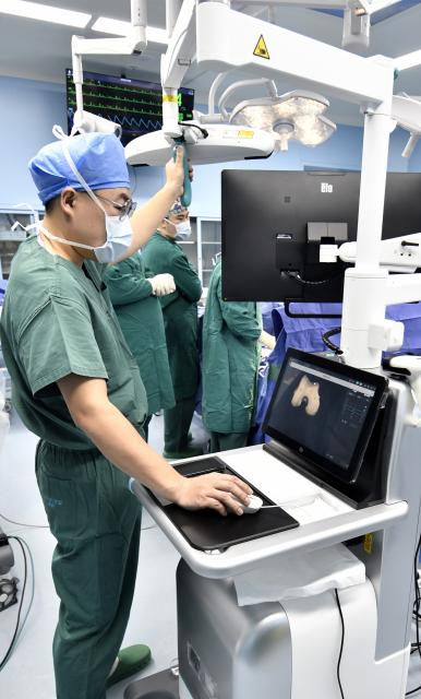 (260203) -- BEIJING, Feb. 3, 2026 (Xinhua) -- Experts perform orthopedic surgery using a robotic system at the Tongzhou branch of Beijing Anzhen Hospital in Beijing, capital of China, Feb. 3, 2026. Beijing Anzhen Hospital, designated by the Beijing municipal government as the city's first demonstration unit for "robots plus medical" applications, currently has 25 types of medical robots undergoing clinical trials. 
   These robots are deployed across various departments including outpatient clinics, pharmacies, wards, operating rooms, and catheterization rooms. 
   Serving as intelligent assistants to doctors, these robotic "staff members" are becoming a driving force in the hospital's smart transformation and upgrade. (Xinhua/Li Xin)