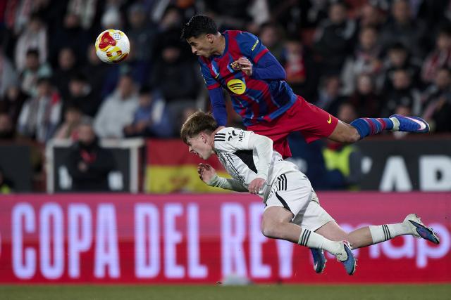 (260204) -- ALBACETE, Feb. 4, 2026 (Xinhua) -- Joao Cancelo (top) of Barcelona vies with Dani Bernabeu of Albacete during the Copa del Rey quarterfinal match between Albacete and Barcelona in Albacete, Spain, Feb. 3, 2026. (Str/Xinhua)