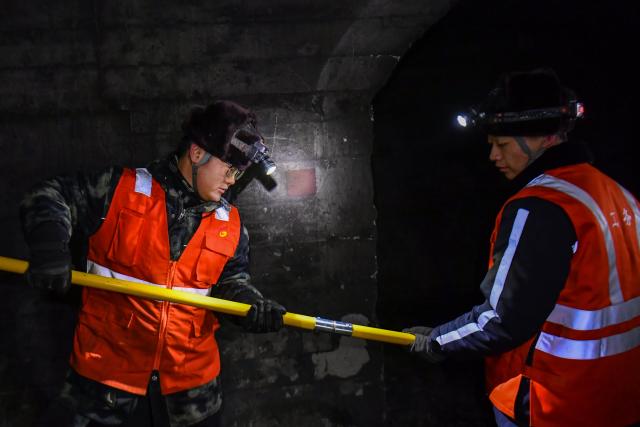 (260204) -- JINZHONG, Feb. 4, 2026 (Xinhua) -- Technicians prepare to break ice in a railway tunnel in north China's Shanxi Province, Feb. 3, 2026.
  A team of maintenance technicians, most born in the 2000s, has spent the winter months shoveling and removing ice from railway tunnels deep in the mountainous terrain in Shanxi province to safeguard passengers' trips.
  Embarking on the patrol journey at dawn, they trek more than nine kilometers every day to clear ice in seven railway tunnels. The arduous chipping, shoveling and transporting of large ice chucks means the technicians are totally burned out after a day of work.
  During the Chinese New Year, the team will stay on duty to ensure the safe operation of train services. Through their efforts, thousands more who have been working far from their hometowns for almost a year will be able to ride the train and return home safe and sound. (Xinhua/Cao Yang)