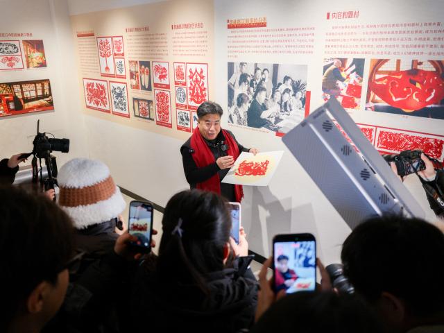 (260204) -- HOHHOT, Feb. 4, 2026 (Xinhua) -- Duan Jianjun, a national representative inheritor of Horinger paper-cutting, introduces a piece of paper-cutting work at an exhibition hall of the Horinger Tuchengzi Archaeological Site Park in Horinger County, north China's Inner Mongolia Autonomous Region, Feb. 4, 2026. Events featuring the traditional craft of Horinger paper-cutting, a national intangible cultural heritage, were held in Horinger County on Wednesday to mark "Lichun," or the Beginning of Spring, the first of the 24 solar terms on the Chinese lunar calendar, and to welcome the upcoming Spring Festival. (Xinhua/Ma Jinrui)