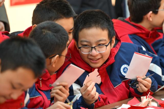(260204) -- HOHHOT, Feb. 4, 2026 (Xinhua) -- Students learn Horinger paper-cutting skills at an exhibition hall of the Horinger Tuchengzi Archaeological Site Park in Horinger County, north China's Inner Mongolia Autonomous Region, Feb. 4, 2026. Events featuring the traditional craft of Horinger paper-cutting, a national intangible cultural heritage, were held in Horinger County on Wednesday to mark "Lichun," or the Beginning of Spring, the first of the 24 solar terms on the Chinese lunar calendar, and to welcome the upcoming Spring Festival. (Xinhua/Bei He)