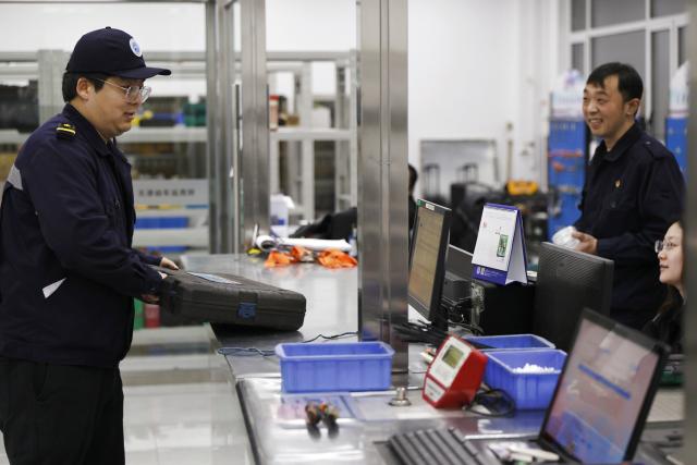 (260204) -- TIANJIN, Feb. 4, 2026 (Xinhua) -- Li Qiwei (L) collects maintenance tools at an electric multiple unit (EMU) maintenance depot in north China's Tianjin Municipality, on Feb. 1, 2026. Several EMU trains are neatly lined up for "health checkups" inside a maintenance depot in Tianjin at the night of Feb. 1, right before the start of Spring Festival travel rush, the annual homeward journey in China, and also the world's largest human migration. 
   To ensure safe and punctual departure of these trains, Li Qiwei, the leader of a maintenance team, had to work overnight with more than 40 mates on his team to perform full-body examination for 28 sets of EMUs - a workload about 20 percent higher than that of a normal workday.
   Li has been working at the maintenance depot after he graduated with a degree in vehicle engineering from the Dalian Jiaotong University. Eight years of diligence saw him rising from green hands to a competent group leader. He said he felt very lucky to be able to contribute to the safety operation of the bullet trains, which are reuniting million of people with their families during the Spring Festival travel rush. (Xinhua/Li Ran)
